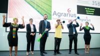 The JSE welcomes Agrarius to the debt market: Stakeholders from Agrarius and the Johannesburg Stock Exchange, raising their hands, smiling and blowing vuvuzelas in celebration.